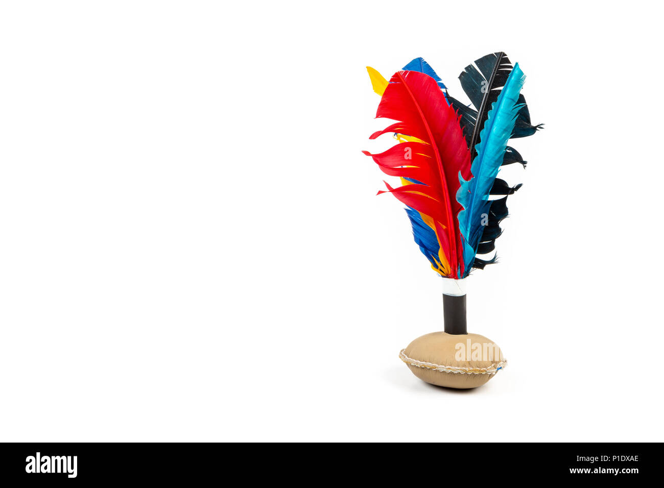 Handmade shuttlecock toy with colourful feathers on white background. Stock Photo