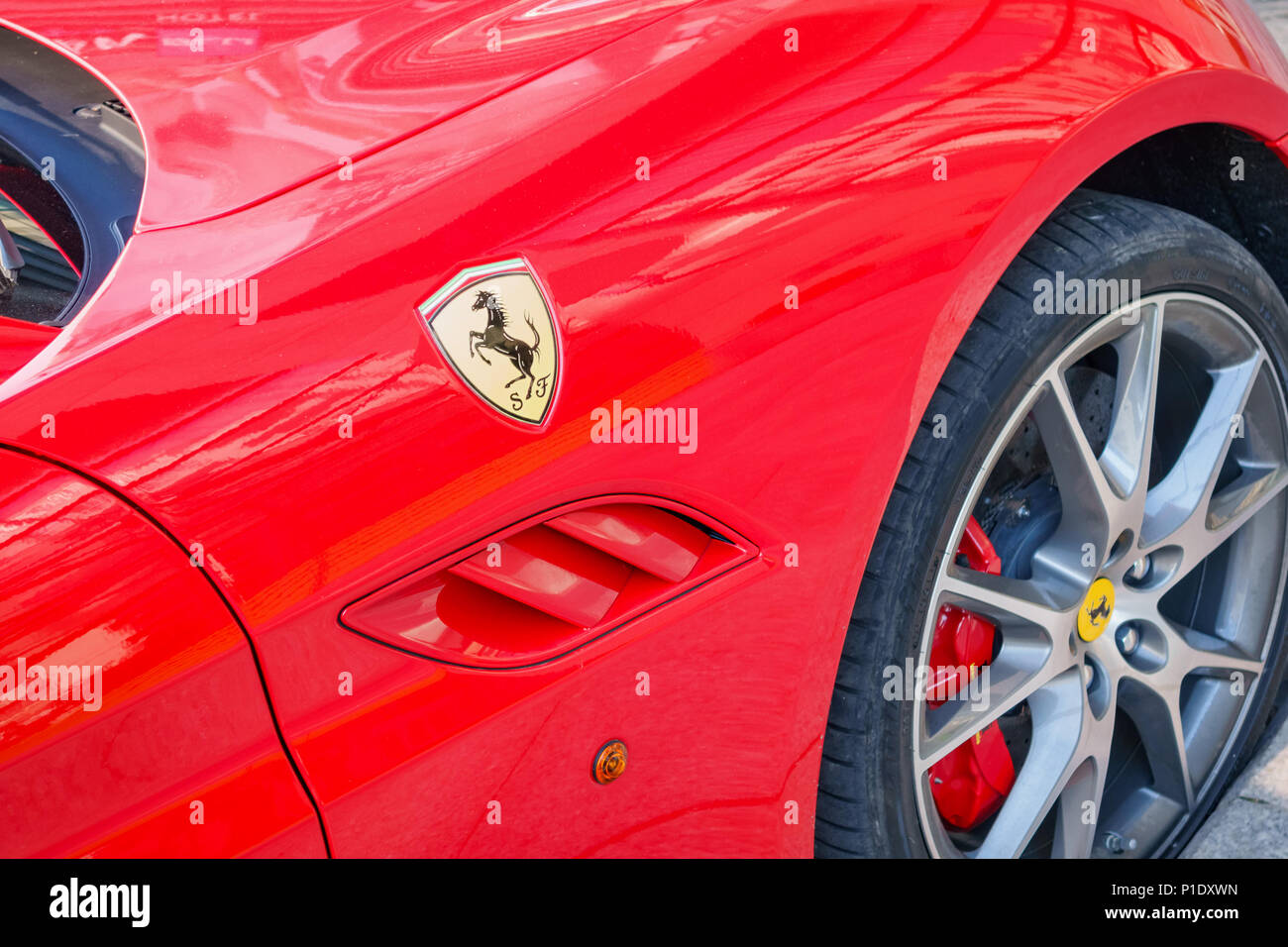 Logo and side of a red Ferrari sports car Stock Photo