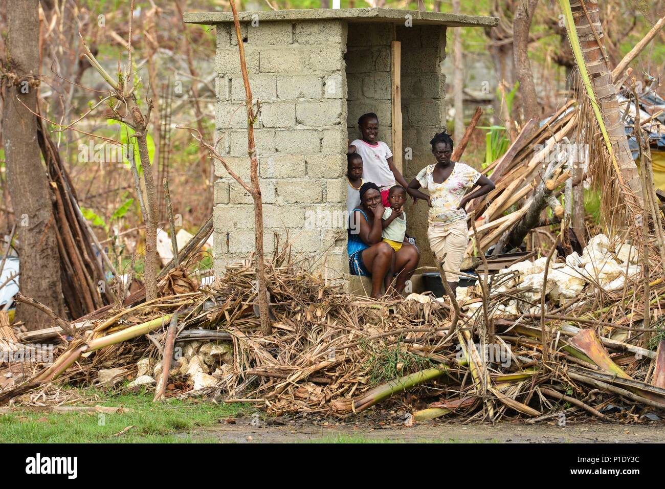 Locals of Ansed’Hainault stand by as supplies are delivered by Sailors