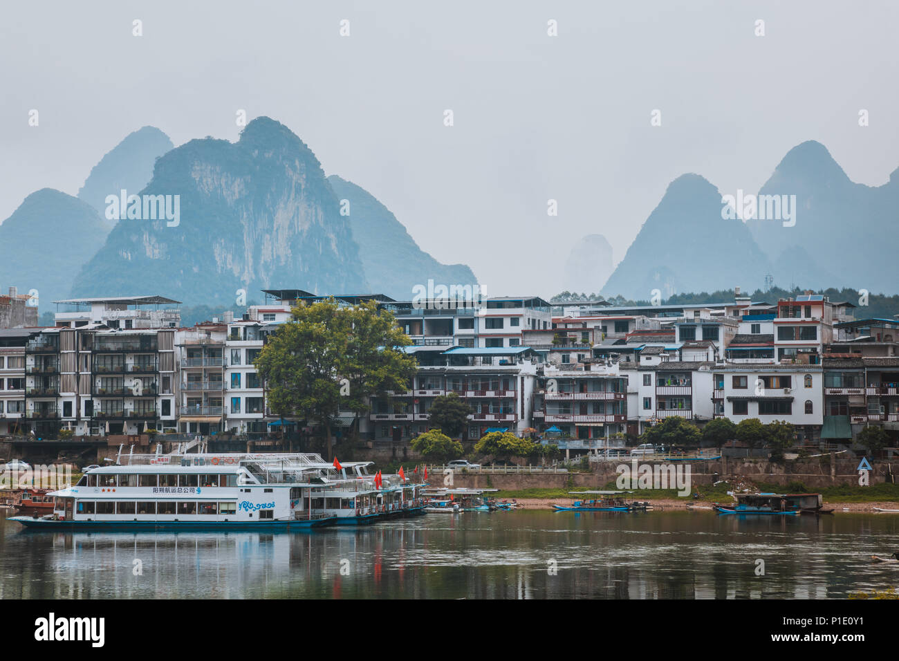 YANGSHUO, CHINA - MAY 26, 2018: Scenic landscape at Yangshuo County of Guilin. Li River (Lijiang River). Pleasure boats at the pier in Yangshuo Town,  Stock Photo