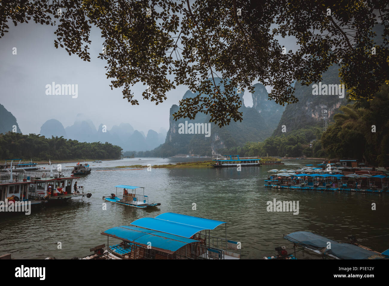 Li River (Lijiang River). Pleasure boats at the pier in Xingping Town, China. Stock Photo