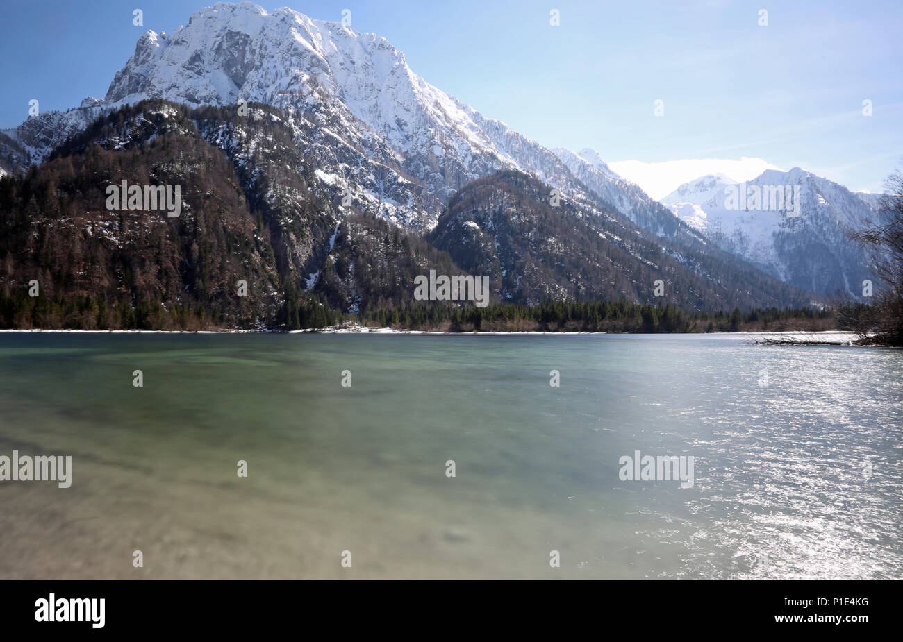 alpine little lake called Predil Lake Northern Italy and the mountains with long exposition thecnique Stock Photo