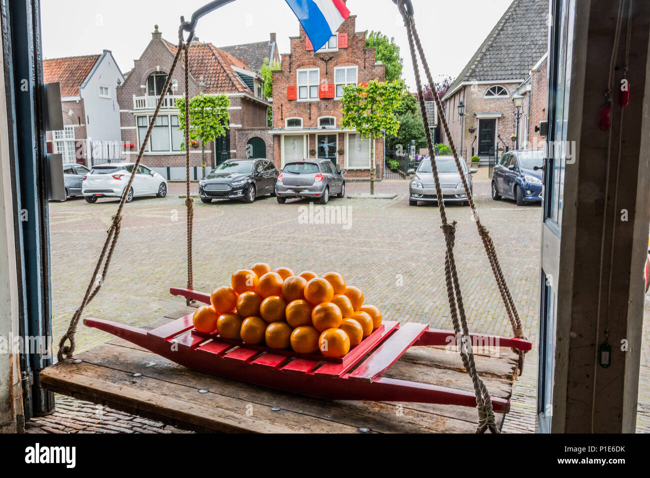 Dutch cheeses in a traditional transport cart of the place and in an old scale in the village of edam. netherlands Stock Photo