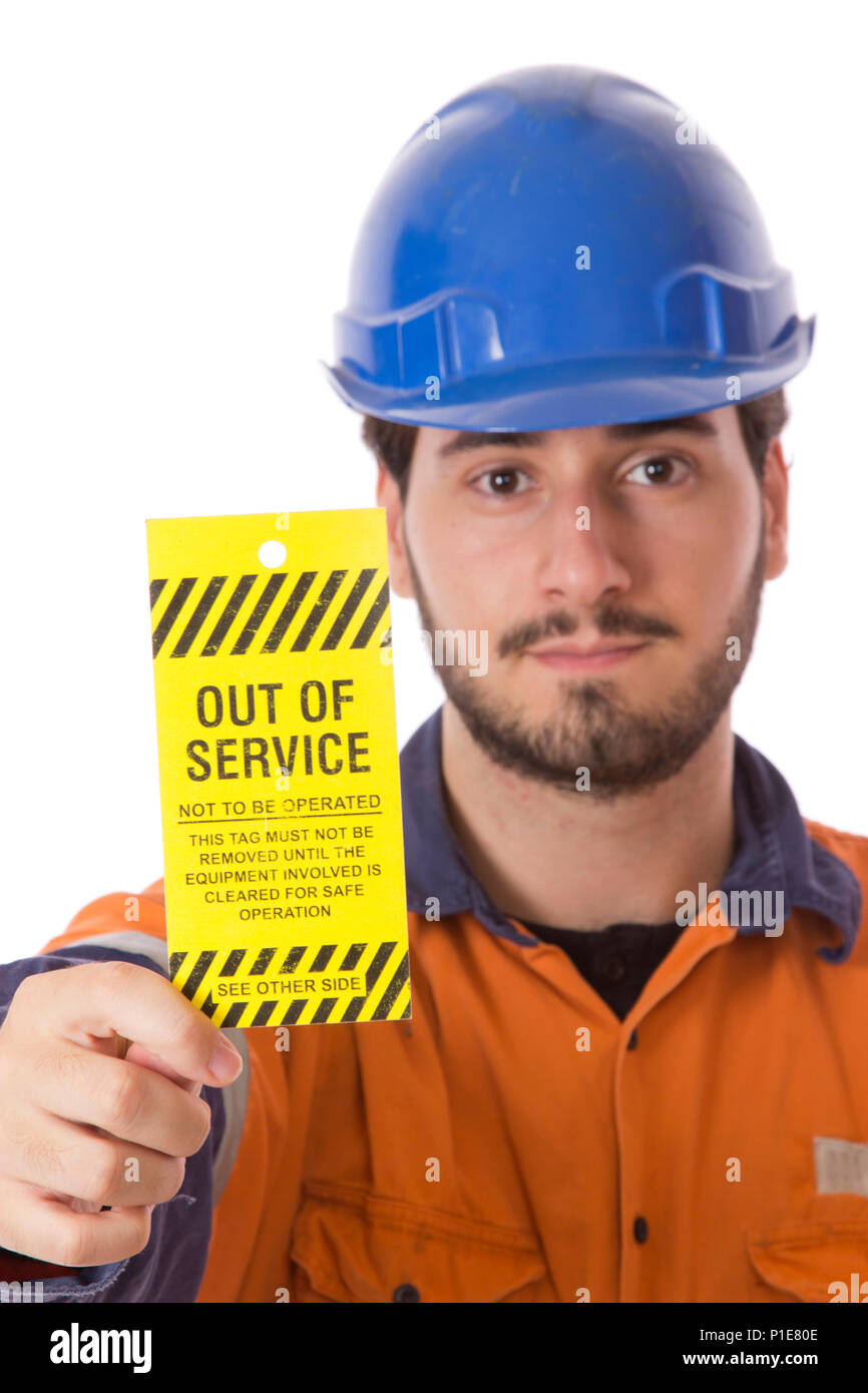 A worker showing an Out of Service Tag, important for tagging out unsafe machinery. Stock Photo