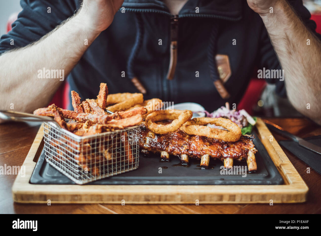 Man is eating fast food in a restaurant, Brighton, England Stock Photo
