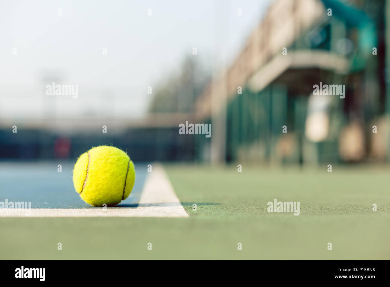 High-angle close-up of a fluorescent yellow tennis ball in the court Stock Photo