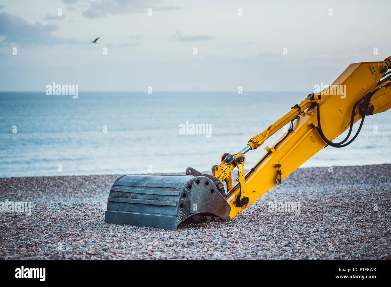Excavator on the pebble beach, Brighton, England Stock Photo