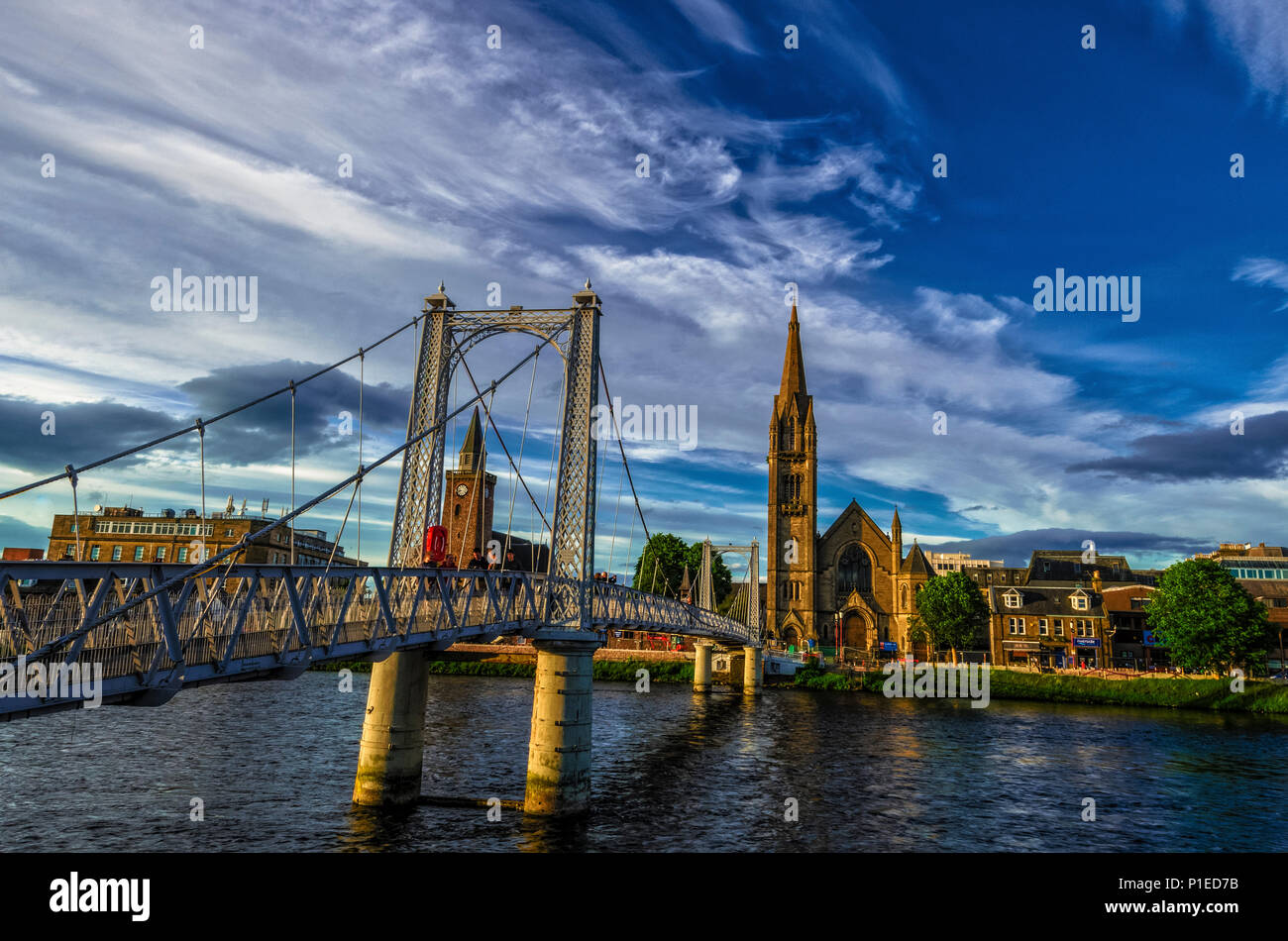 The footbridge on river Ness joining Huntly Street and Bank Street in Inverness with a pre-golden hour light on a late summer afternoon. Stock Photo