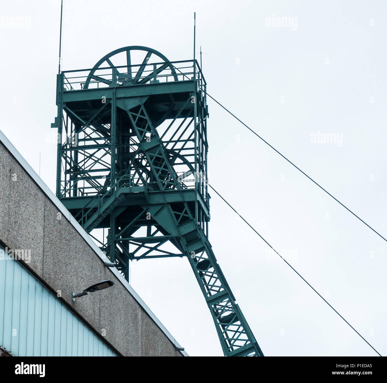 Mining tower of the "Asse" mine, a research mine for radioactive waste near Wolfenbuettel in Lower Saxony Germany, grey sky Stock Photo