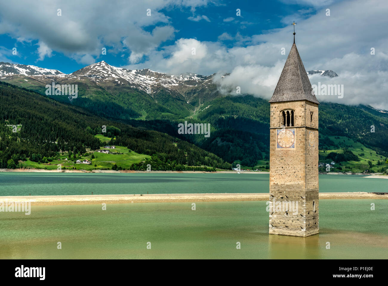 The half submerged bell tower of  Curon Venosta - Graun im Vinschgau, Trentino Alto Adige - South Tyrol, Italy Stock Photo