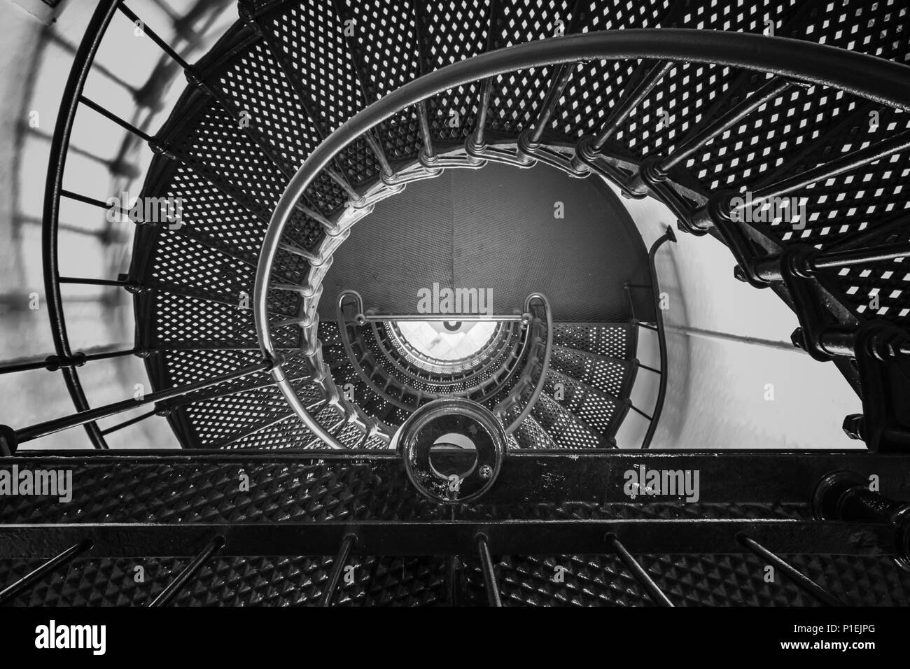 Looking down a metal spiral staircase from the top. Stock Photo