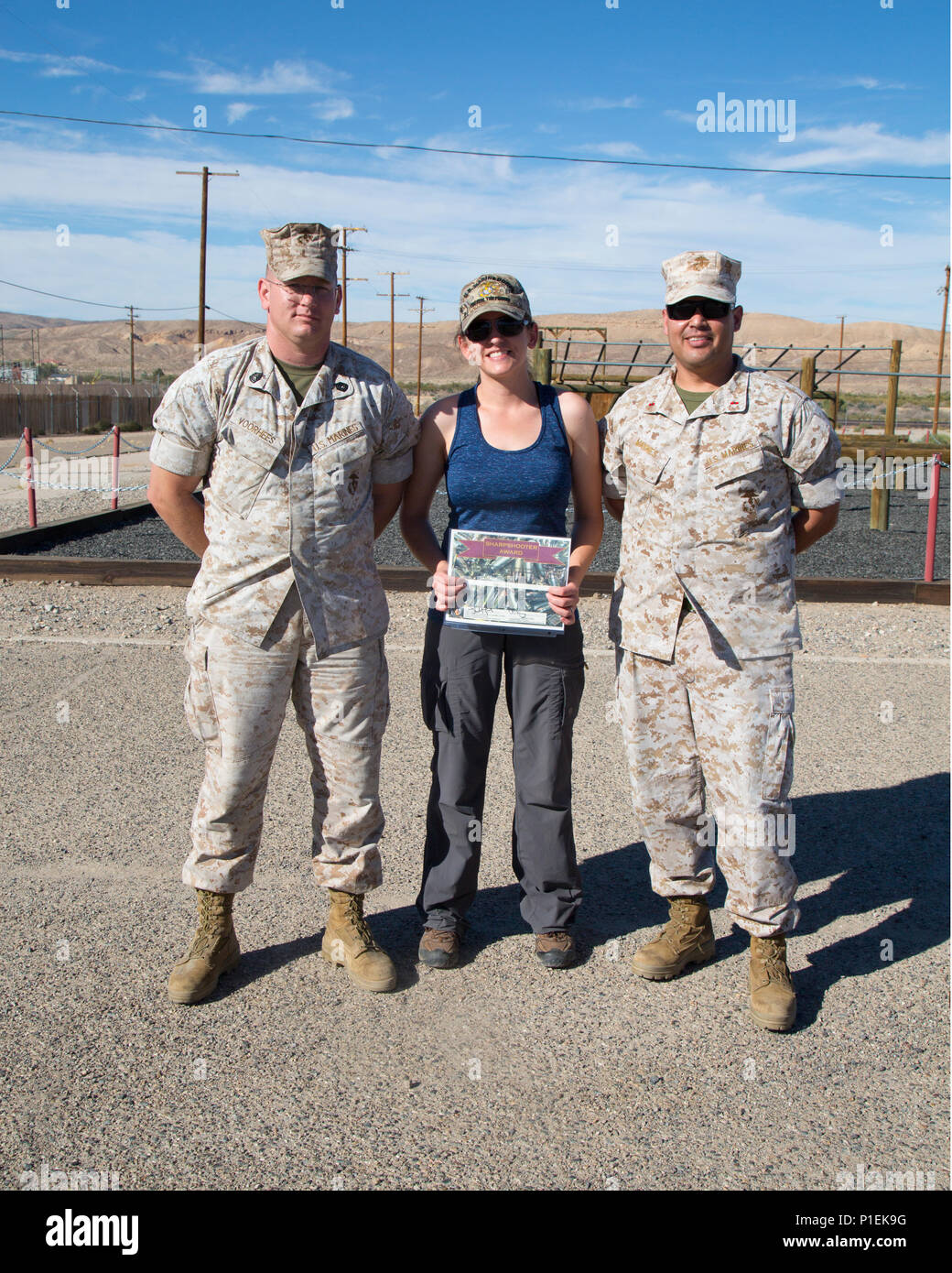 Jamie Teale poses with Gunnery Sgt. Michael Voorhees and Chief Warrant