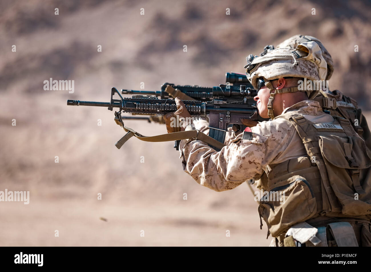 A U.S. Marine with weapons platoon, Fox Company, 2nd Battalion, 7th Marine Regiment, Special Purpose Marine Air - Ground Task Force - Crisis Response - Central Command, shoots his M16 rifle during a live - fire range during Mission Rehearsal Exercise 2016 near the southern border of the Hashemite Kingdom of Jordan,  Sept. 11, 2016. The MRX is a collective training event where the MAGTF elements collaborate to refine individual and cooperative capabilities. SPMAGTF - CR – CC is a self-sustaining expeditionary unit, designed to provide a broad range of crisis response capabilities throughout the Stock Photo
