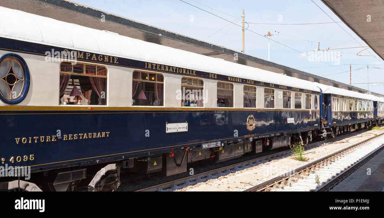 Venice Simplon Orient Express luxury train in Venice, St Lucia Station, Italy. Restaurant car and carriages at platform receding view Stock Photo