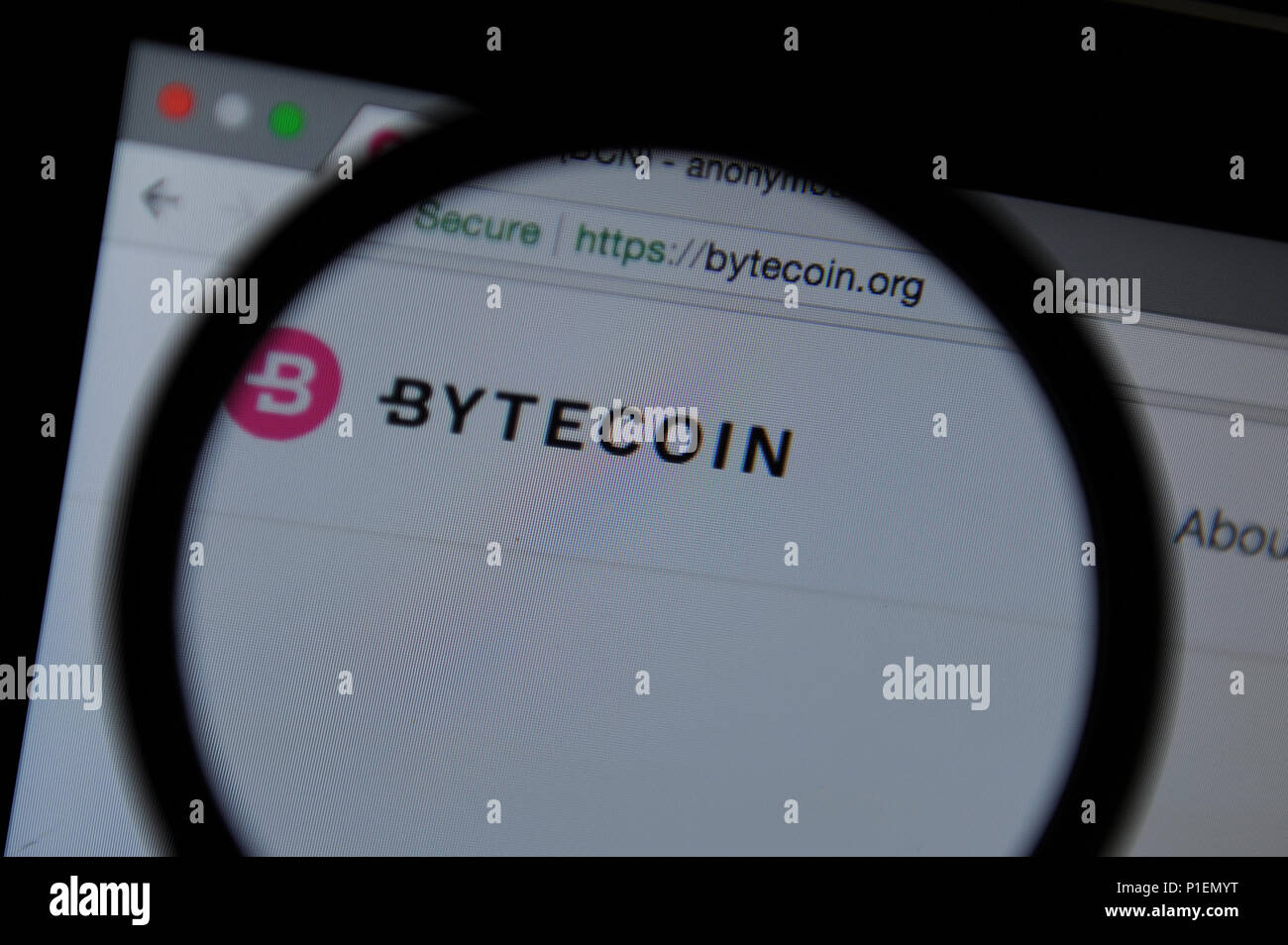 Bytecoin cryptocurrency website seen through a magnifying glass Stock Photo