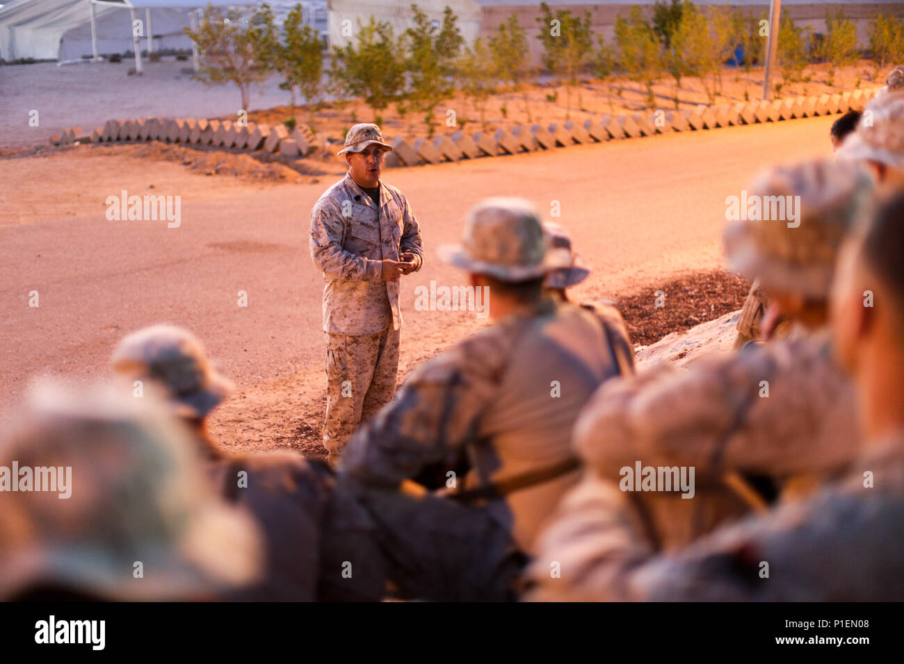U.S. Marine Corps Sgt. Maj. Gabriel Macias, 2nd Battalion, 7th Marine Regiment sergeant major, talks with his Marines during Mission Rehearsal Exercise 2016 near the southern border of the Hashemite Kingdom of Jordan,  Sept. 11, 2016. The MRX is a collective training event where the MAGTF elements collaborate to refine individual and cooperative capabilities. SPMAGTF - CR – CC is a self-sustaining expeditionary unit, designed to provide a broad range of crisis response capabilities throughout the Central Command area of responsibility, using organic aviation, logistical, and ground combat asse Stock Photo