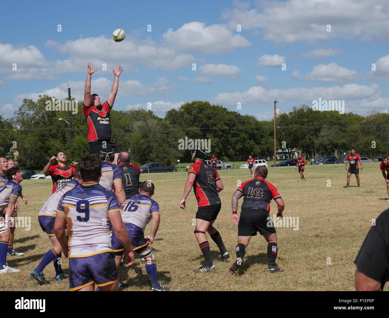 The San Antonio Rugby Football Club, a 45 year old organization formed by doctors from Brooke Army Medical Center in 1971, execute a ‘lineout’ to throw the ball back into play in their match against the British Army Medical Services Rugby Team on October 15, at the Wheatley Sports complex. The visiting British broke open a close match in the second half and won 45-10. (U.S. Army photo by Robert A. Whetstone/Released) Stock Photo