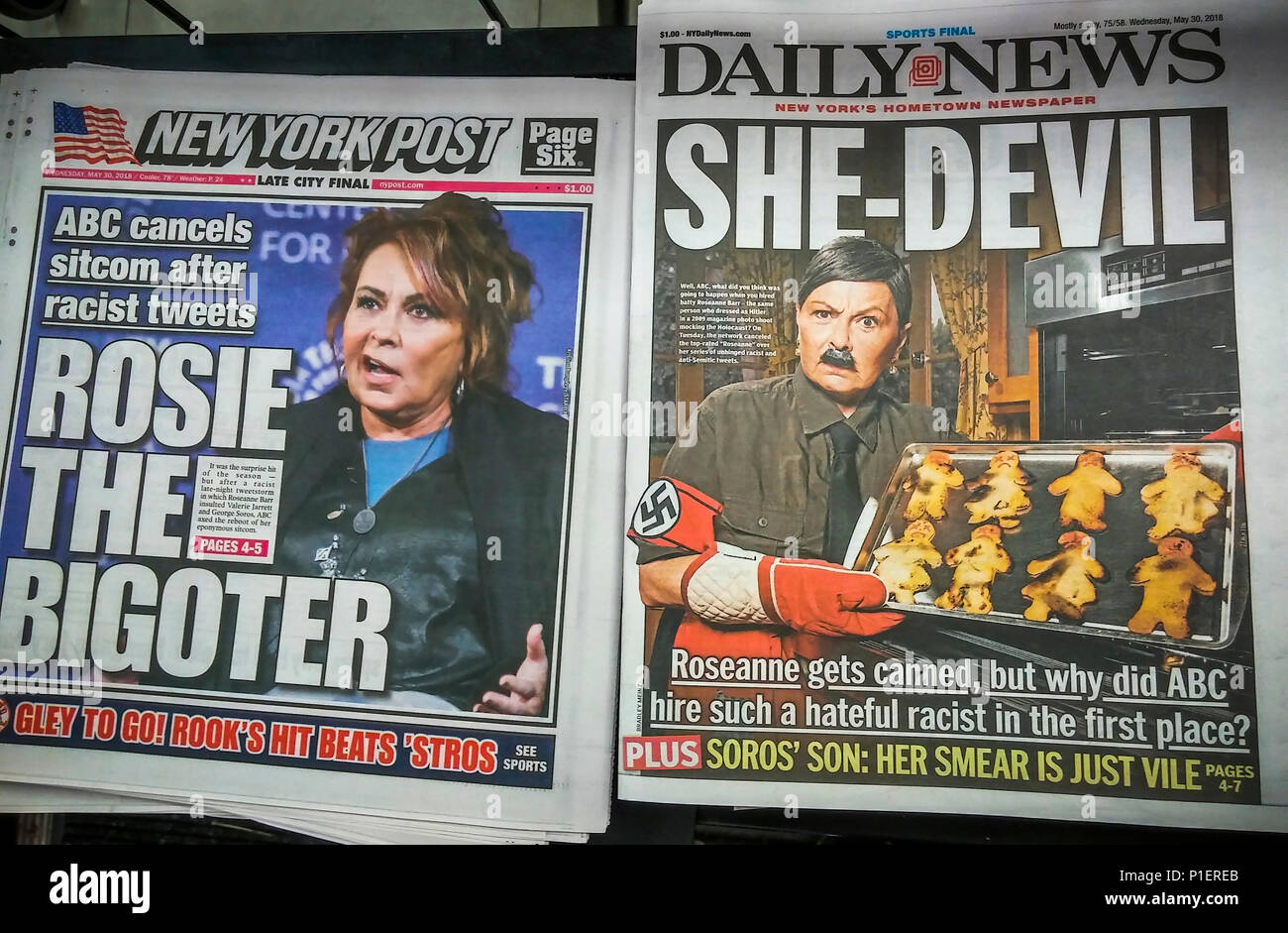 Headlines of New York tabloid newspapers are seen on Wednesday, May 30, 2018 reporting on the cancellation by ABC of 'Roseanne' because of racist comments made by the titular star Roseanne Barr referencing former Obama aide Valerie Jarrett. (© Richard B. Levine) Stock Photo