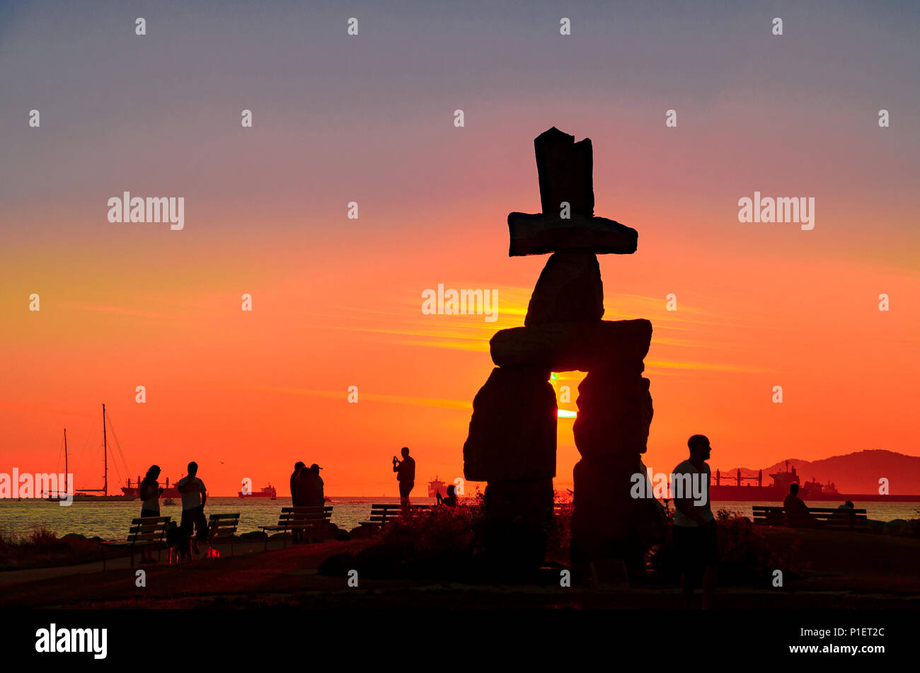 Silhouetted People And Inukshuk At Sunset English Bay Vancouver