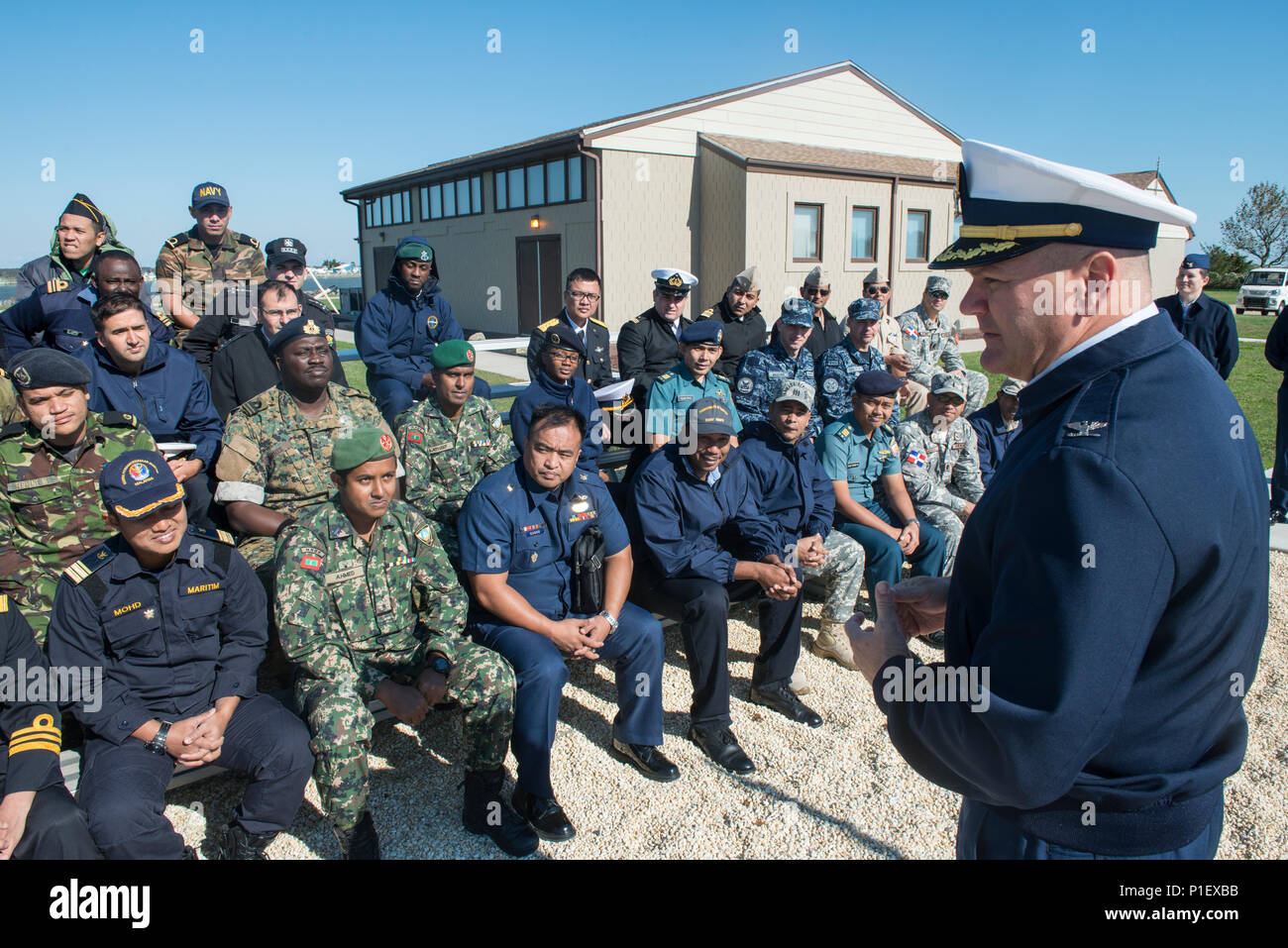 Captain Owen Gibbons, commanding officer of Coast Guard Training Center Cape May, N.J., speaks to members of foreign military during their visit to the training center, Monday, Oct. 24, 2016. The group is participating in an international training opportunity designed to familiarize foreign military members with the Coast Guard as well as to learn about American history and culture. Twenty-seven countries have members participating in this class. (U.S. Coast Guard photo by Chief Warrant Officer John Edwards/Released) Stock Photo