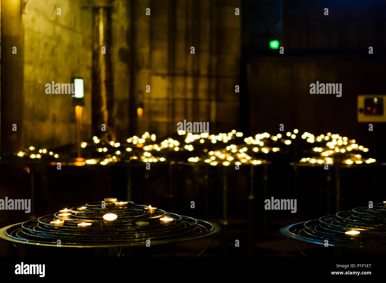 Lit candles in Notre Dame Cathedral in Paris. Shallow depth of field