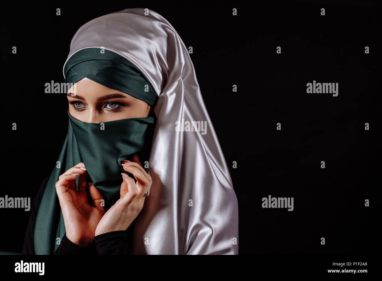 close up portrait of Mohammedan taking off her hijab Stock Photo