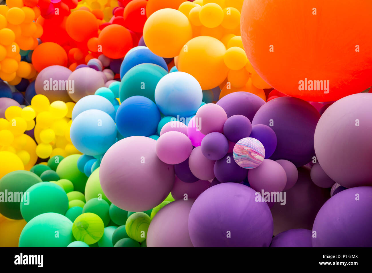 Bright abstract background of jumble of rainbow colored balloons