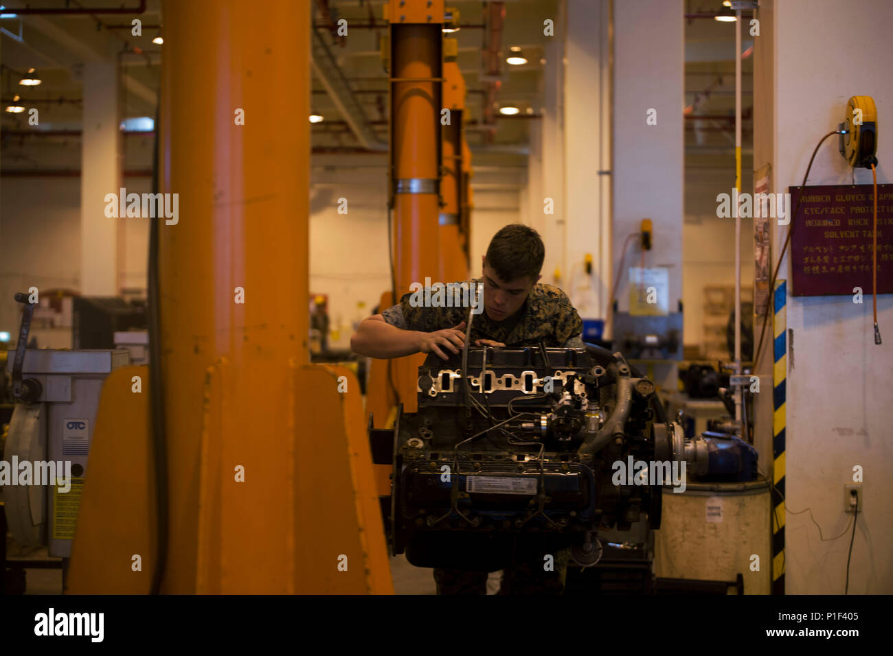 A Marine works on a High Mobility Multipurpose Wheeled Vehicle (HMMWV ...