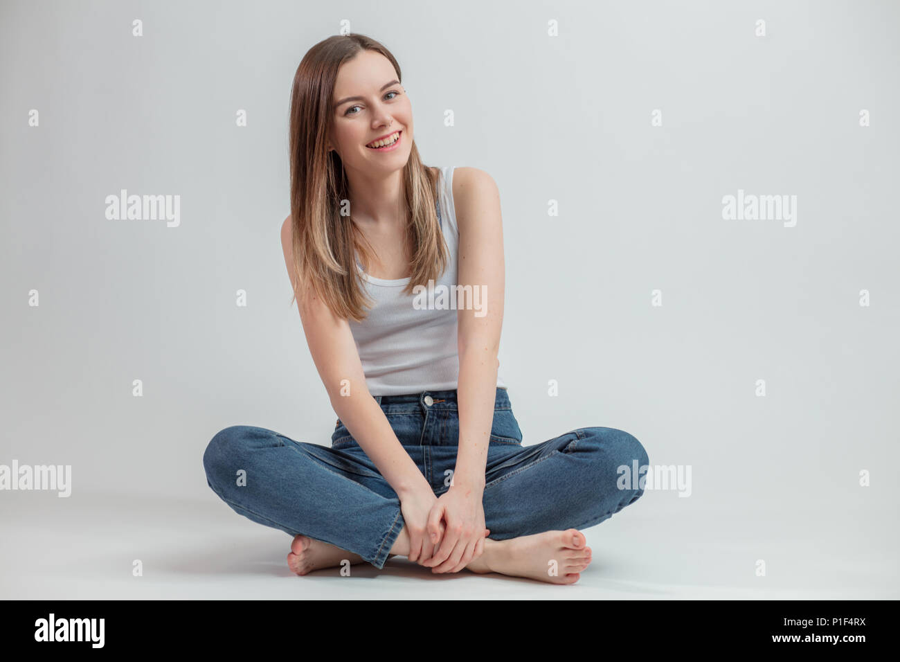 Crossed legs wearing blue jeans hi-res stock photography and images - Alamy