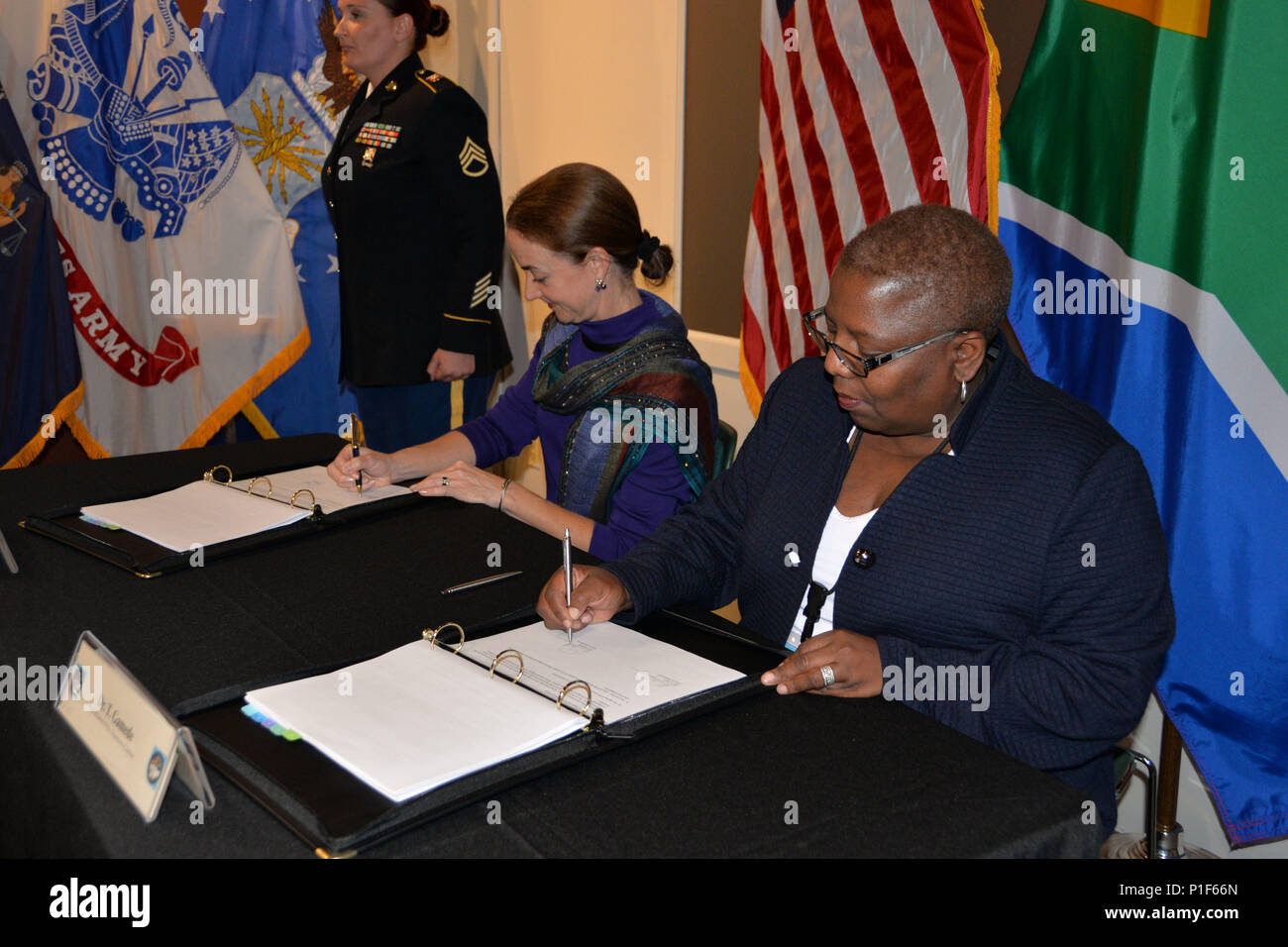 Bilateral Defense Committee Co-Chairs Amanda Dory, U.S. Deputy Assistant Secretary of Defense for African Affairs, and her counterpart, Dr. Thobelile Gamade, Chief of South African Defense Policy, Strategy and Planning, sign the executive summaries of the 2016 meeting October 26 at the New York State Military Museum in Saratoga Springs, N.Y. The senior leaders of the South African National Defense Forces discussed training and exercise opportunities for 2017 during the U.S. and Republic of South Africa. The meeting was hosted by the New York National Guard, a National Guard Bureau state partne Stock Photo