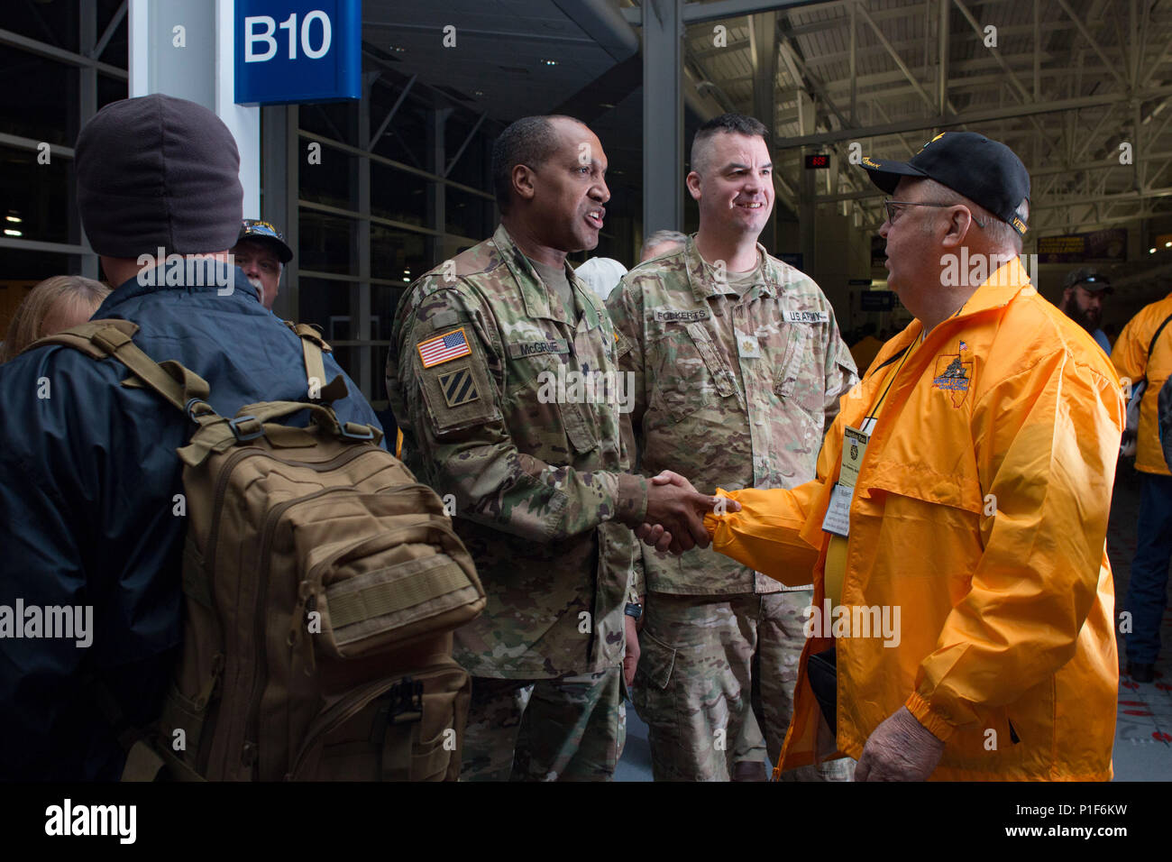 Lt. Col. Arthur McGrue, the executive officer of First Army Headquarters, shakes the hand of a veteran boarding an honor flight at the Quad City International Airport, Ill., Oct. 27, 2016. Honor Flight of the Quad Cities, a chapter of the Honor Flight Network, organizes flights for veterans of World War II and the Korean and Vietnam Wars to visit memorials dedicated to them in Washington, D.C. Volunteers, known as “guardians,” accompany the veterans to keep them company and assist as needed. Approximately 95 veterans and 65 guardians participated in this flight. (Photo by Staff Sgt. Ian M. Kum Stock Photo
