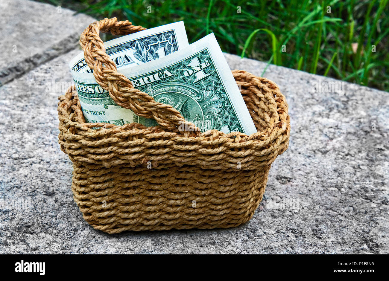 Miniature Basket with One Dollar Bill Stock Photo