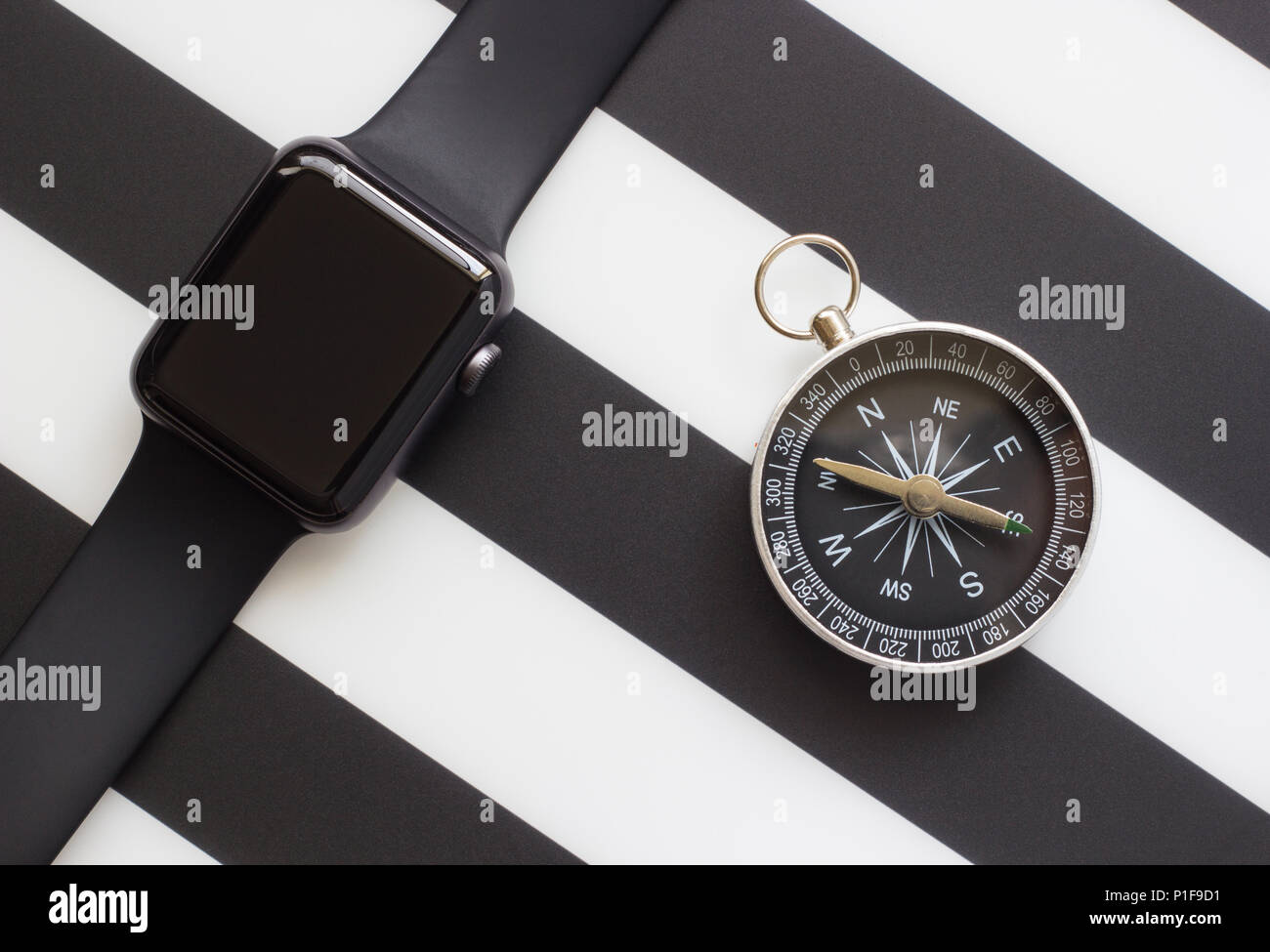 clock and compass on a black and white background Stock Photo