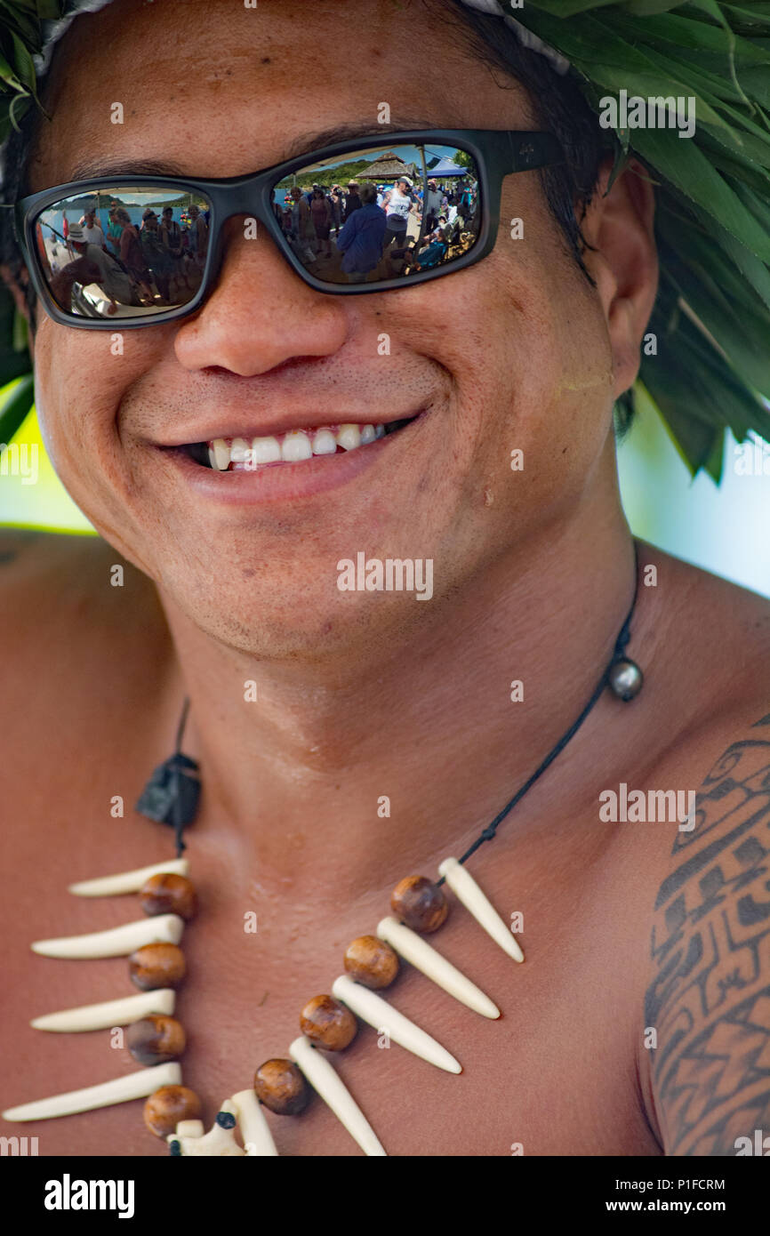 Tattooed Polynesian male host in traditional attire on PAUL GAUGUIN CRUISE at Huahine Island Stock Photo