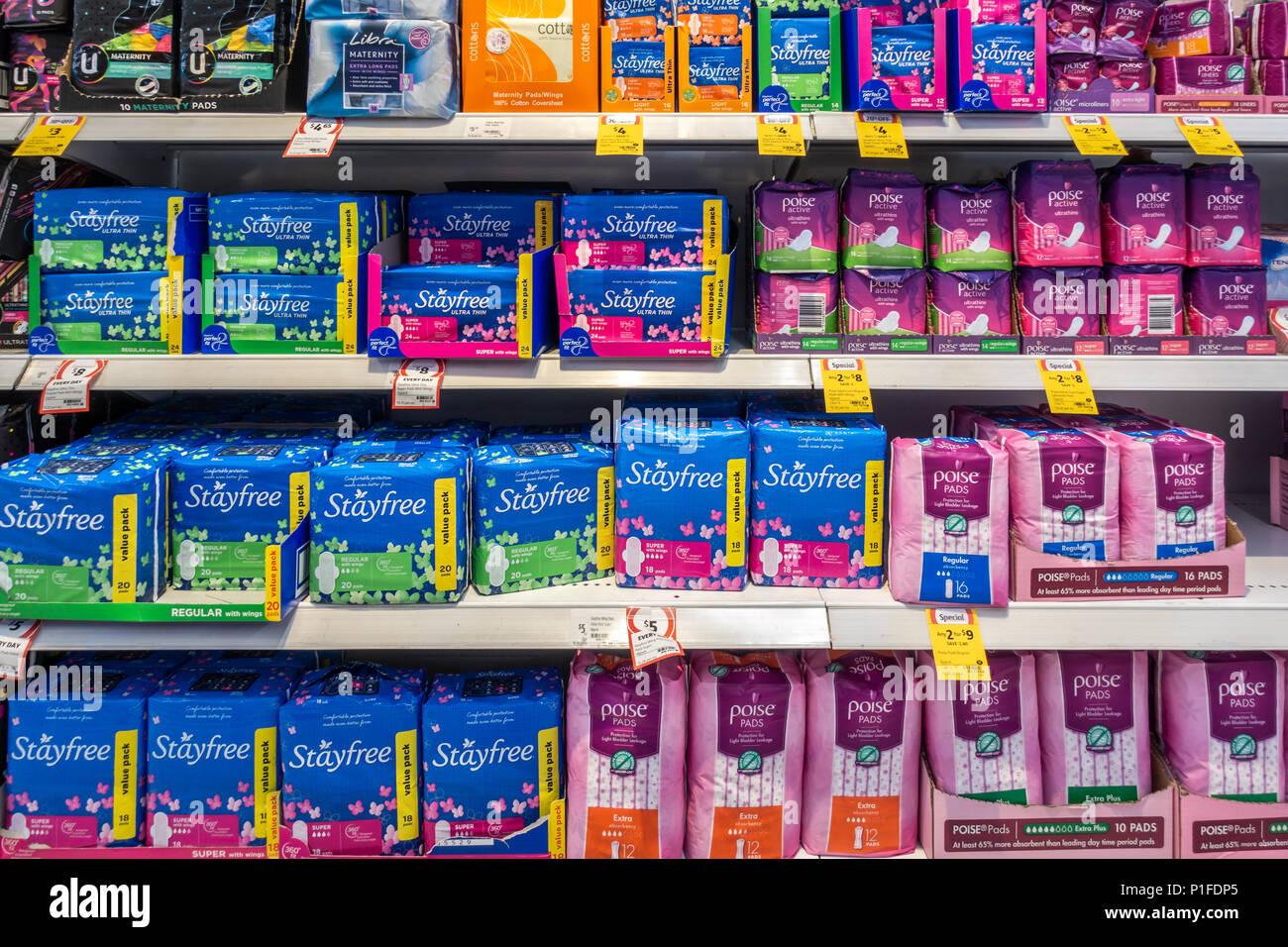 A variety of sanitary napkins placed on shelf in supermarket for customers to choose. Melbourme, VIC Australia. Stock Photo