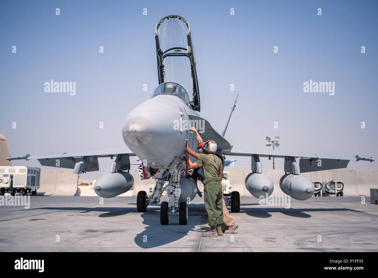 U.S. Marines with Marine All-Weather Fighter Attack Squadron 533, Special Purpose Marine Air-Ground Task Force - Crisis Response - Central Command 16.2, inspect an F/A-18D before takeoff at an undisclosed location in Southwest Asia, Oct. 15, 2016. VMFA(AW)-533 departed the CENTCOM area of responsibility, completing deployment as part of the Aviation Combat Element of SPMAGTF-CR-CC.  The squadron conducted strikes in support of Operation Inherent Resolve, the operation to eliminate the ISIL terrorist group and the threat they pose to Iraq, Syria, and the wider international community. (U.S. Mar Stock Photo