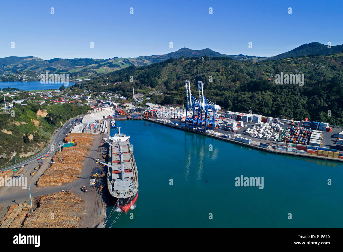 Log terminal and ship, Port of Otago, Port Chalmers, Dunedin, Otago, South Island, New Zealand - drone aerial Stock Photo
