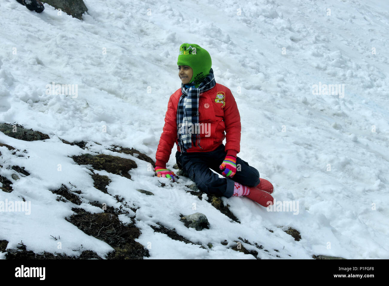 Portrait of a child in the snow mountain valley. Snow valley at Zero Point North Sikkim in India. The Yumthang Valley or Sikkim Valley. Stock Photo