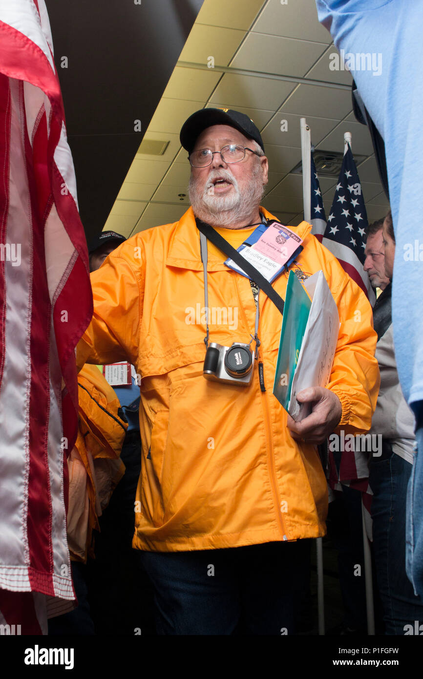A veteran deboards an honor flight at the Quad City International Airport, Ill., Oct. 27, 2016. Honor Flight of the Quad Cities, a chapter of the Honor Flight Network, organizes flights for veterans of World War II and the Korean and Vietnam Wars to visit memorials dedicated to them in Washington, D.C. Volunteers, known as “guardians,” accompany the veterans to keep them company and assist as needed. Approximately 95 veterans and 65 guardians participated in this flight. (Photo by Staff Sgt. Ian M. Kummer, First Army Public Affairs) Stock Photo