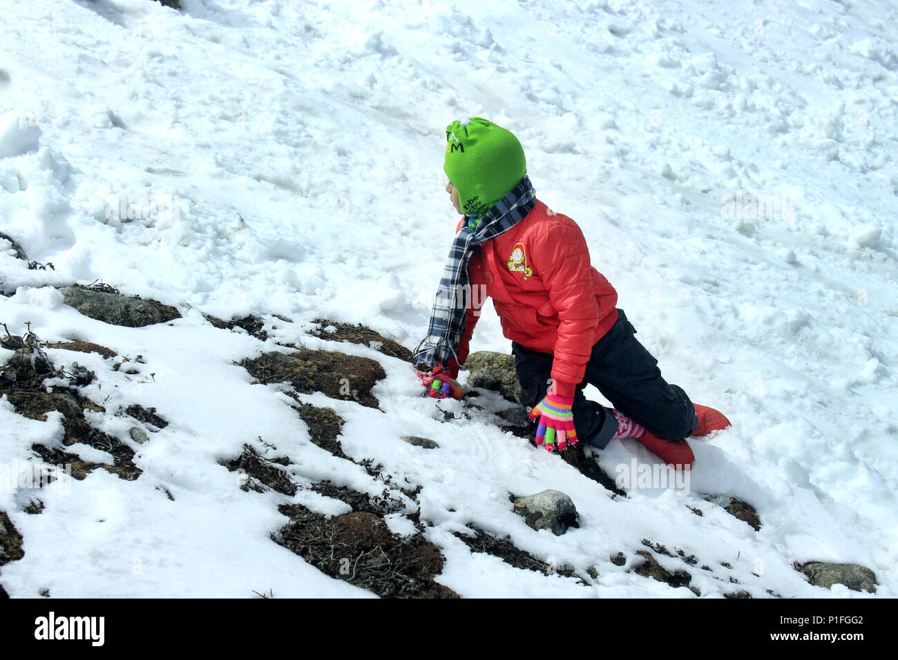 Portrait of a child in the snow mountain valley. Snow valley at Zero Point North Sikkim in India. The Yumthang Valley or Sikkim Valley. Stock Photo