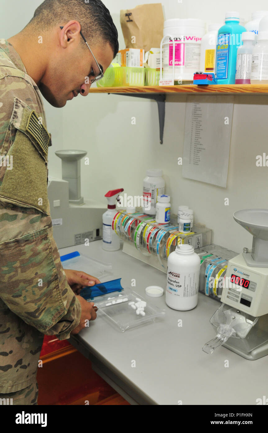 Spc. Elijah Gould, pharmacy specialist with the 31st Combat Support Hospital and Hopewell, N.J. native, counts out a prescription for a patient Oct. 25, 2016 at Camp Arifjan, Kuwait. Gould along with a small team of Soldiers operate the 31st CSH pharmacy providing pharmaceutical support to patients suffering from injuries and illnesses throughout the ARCENT area of operations. The team processes more than 3,500 outpatient prescriptions a month to service members and civilians while providing support to inpatient care and other facilities throughout the region. (U.S. Army photo by Sgt. Aaron El Stock Photo
