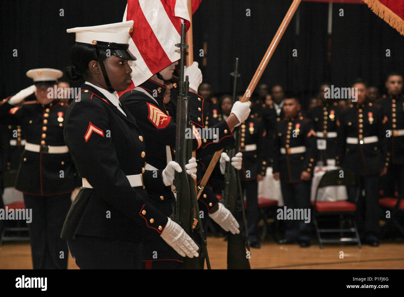The Marine Corps Combat Service Support Schools color guard render a rifle salute for the playing of the national anthem during the student Marine Corps birthday ball ceremony held at Camp Lejeune, N.C., Oct. 29, 2016. Students from Financial Management School, Ground Supply School, Personnel Administration School, and Logistics Operations School attended their first Marine Corps Ball to celebrate the 241st Marine Corps Birthday (U.S. Marine Corps photo by Lance Cpl. Jose D. Villalobosrocha) Stock Photo