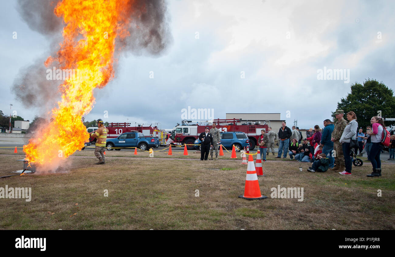 A firefighter assigned to the 786th Civil Engineer Squadron demonstrates to a crowd the effects