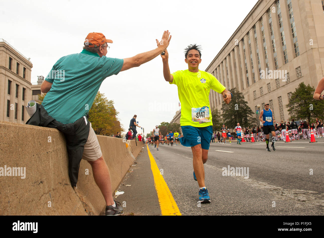 Sony Sawad, right, participant in the 41st Marine Corps Marathon high