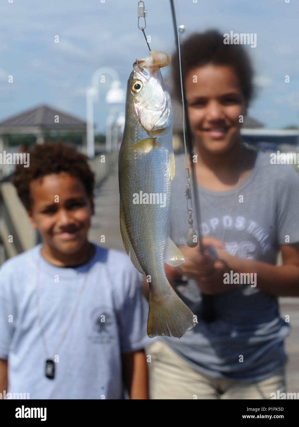 Keith and Olivia Mosley, children of 1st Lt. Desiree Mosley, 81st Medical Operations Squadron emergency room nurse, showcase a fish they caught during the Kids’ Fishing Rodeo at the marina Oct. 15, 2016, on Keesler Air Force Base, Miss. Over 90 participants attended the event where prizes were awarded for different categories and free food was available. (U.S. Air Force photo by Kemberly Groue/Released) Stock Photo