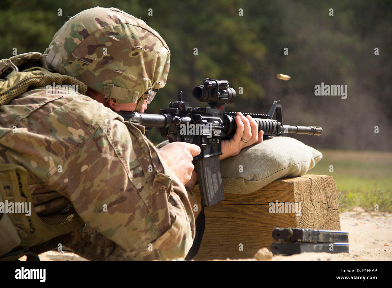 A Soldier assigned to 3rd Military Information Support Battalion, 4th Military Information Support Group, engages pop-up targets during an M4 carbine qualification range, Oct. 27, 2016, at Fort Bragg, North Carolina. Stock Photo
