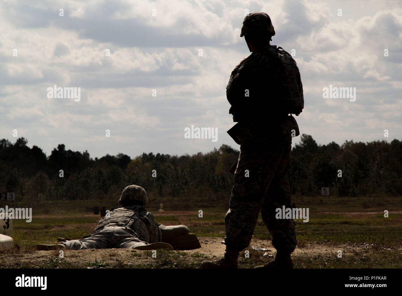 A Soldier assigned to 3rd Military Information Support Battalion, 4th Military Information Support Group, acts as a range safety while other Soldiers engage pop-up targets during an M4 carbine qualification range, Oct. 27, 2016, at Fort Bragg, North Carolina. Stock Photo