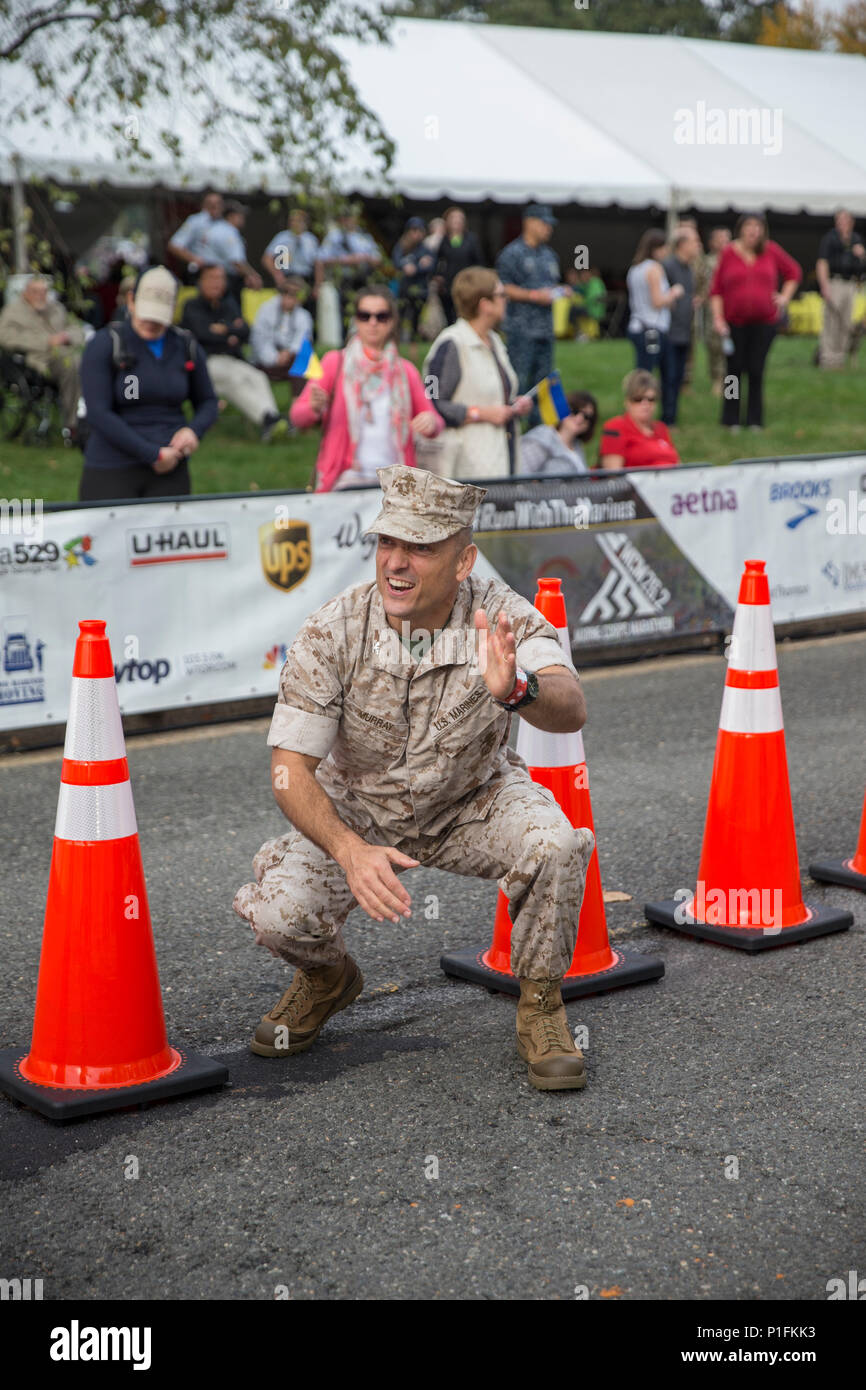 U.S. Marine Corps Col. Joseph M. Murray, command officer, Marine Corps Base Quantico cheers on runners at the finish line of the 41st Marine Corps Marathon, Arlington, Va., Oct. 30, 2016. Also known as 'The People's Marathon,' the 26.2 mile race drew roughly 30,000 participants to promote physical fitness, generate goodwill in the community, and showcase the organizational skills of the Marine Corps. (U.S. Marine Corps photo by Sgt. Alexandria Blanche) Stock Photo