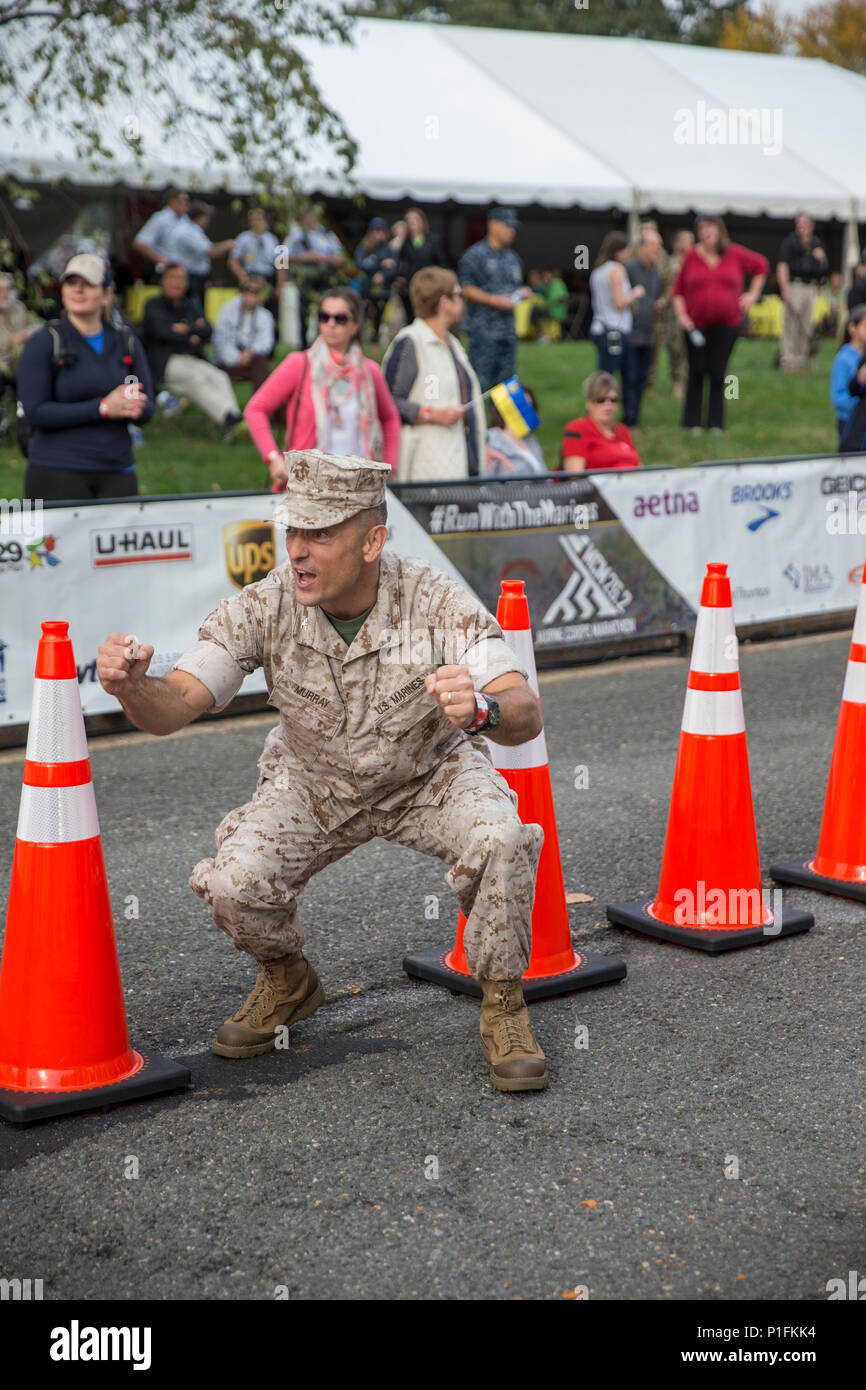 U.S. Marine Corps Col. Joseph M. Murray, command officer, Marine Corps Base Quantico cheers on runners at the finish line of the 41st Marine Corps Marathon, Arlington, Va., Oct. 30, 2016. Also known as 'The People's Marathon,' the 26.2 mile race drew roughly 30,000 participants to promote physical fitness, generate goodwill in the community, and showcase the organizational skills of the Marine Corps. (U.S. Marine Corps photo by Sgt. Alexandria Blanche) Stock Photo