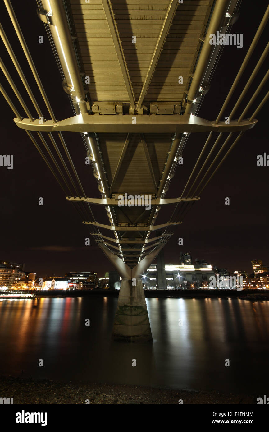 Millenium bridge and st pauls along the Thames River bank UK Stock Photo